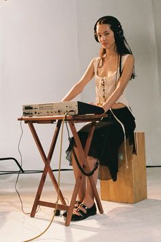 a woman sitting at a table with headphones on