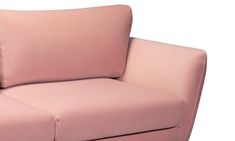 a pink couch with two pillows on the back and one arm folded over it's head