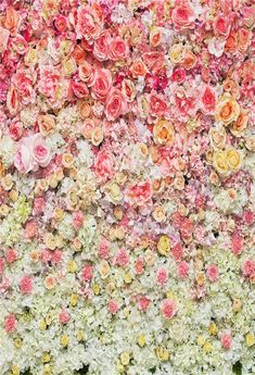 a large flower wall with many different colored flowers on it's sides and bottom half