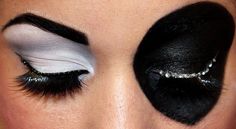 a woman's eye with black and white makeup on her eyeshadp,