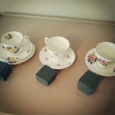 four tea cups and saucers sitting on top of each other