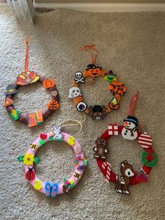 four different bracelets are laying on the floor next to each other, all decorated in different colors