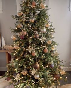 a decorated christmas tree with gold and silver ornaments