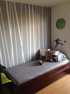 an image of a bedroom with a bed and wallpaper on the walls in different colors