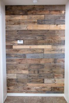 a bathroom with wood planks on the wall