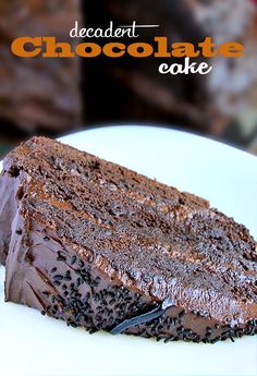 a piece of chocolate cake on a white plate with the words decadent chocolate cake