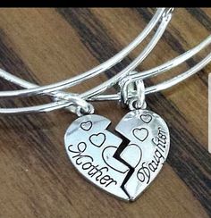 "New Engraved Mother & Daughter Half Heart Charm Silver Plated Adjustable Bangle Bracelet Set ~Includes two bracelets & charms as shown ~Silver plated, engraved Mother & Daughter half heart charm ~Silver plated wire bangle fits wrists 5.5\" to 8.5\" in diameter ~Each half heart charm measure 1\" long x 1/2\" wide Ships within 24 hours of purchase Monday-Saturday" Mother's Day Double Heart Friendship Bracelet, Adjustable Open Heart Bracelet For Mother's Day, Heart Bracelet For Best Friend And Mother's Day, Meaningful Heart Bracelets For Mother's Day, Meaningful Heart-shaped Bracelets For Mother's Day, Heart Bracelet For Best Friend, Heart Bracelet For Mother's Day And Best Friend Gift, Silver Heart Bracelets For Best Friend Gift, Mother's Day Heart-shaped Meaningful Bracelets