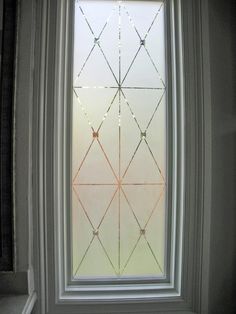 a window with some string lights hanging from it's side and the bottom half