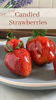 three strawberries on a plate with lavender in the background and text overlay that reads, how to use candied strawberries