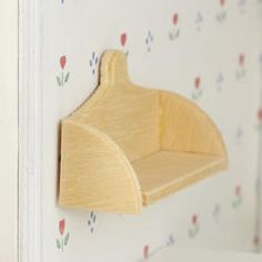 a wooden toothbrush holder hanging on the wall