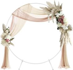 a wedding arch decorated with flowers and greenery