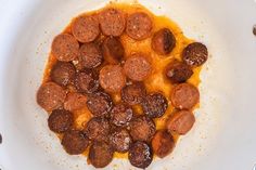 a white plate topped with meatballs and sauce