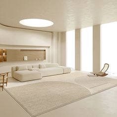 a modern living room with white furniture and large windows