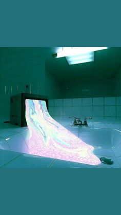 a skateboard ramp in the middle of a white tiled room with lights on it