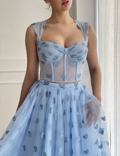 Details:-Baby blue tulle fabric with printed hearts-Two piece dress with detached top and skirt-Corset in a close fitting, with rigilene boning-Tied straps with a decorative bow in the back-Tea length style with side pockets. Blue Tulle Dress With Boned Bodice, Tulle Bodice With Sweetheart Neckline For Party, Light Blue Sheer Bodice Party Dress, Light Blue Party Dress With Sheer Bodice, Light Blue Sheer Bodice Dress For Party, Blue Summer Corset Dress With Boned Bodice, Fitted Blue Tulle Corset Dress, Party Dress With Sheer Bodice In Light Blue, Blue Dress With Boned Bodice And Sweetheart Neckline