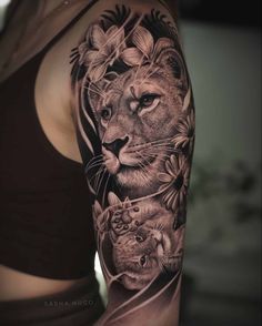 a woman's arm with an image of a lion and two cubs on it