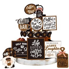 there are many signs on top of the cake that is decorated with coffee related items