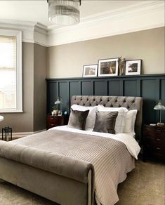 a bedroom with a bed, nightstands and pictures on the wall above it's headboard