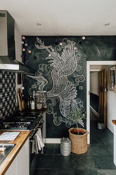 a kitchen with a chalkboard wall painted on the wall next to a stove top oven