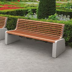 two wooden benches sitting next to each other in front of a flower garden filled with flowers