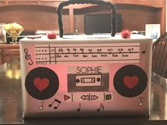 an old school boom box with hearts on it sitting on top of a wooden table