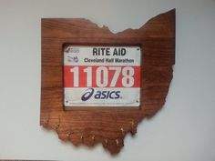 a wooden state shape with a license plate on it that says rite aid cleveland hair marathon