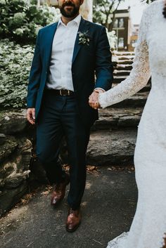 a bride and groom walking hand in hand