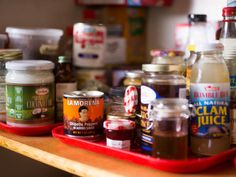 the shelf is full of different types of condiments