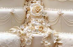 a wedding cake with white flowers on it