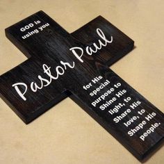 a wooden cross with the words pastor paul on it