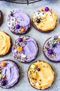 decorated cookies with purple frosting and sprinkles