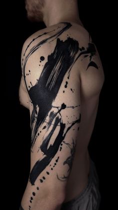 a man's arm with black ink on it, and an abstract design in the middle