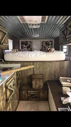 the inside of an rv with bunk beds and storage boxes on the counter top in front of it