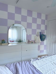 a bedroom with purple and white checkered walls