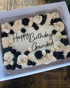 a birthday cake in a box with the words happy birthday grandad written on it