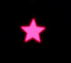 a close up of a traffic light with a pink star on the front and side