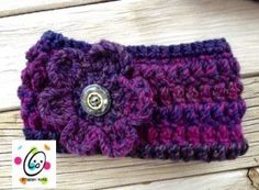 a close up of a purple and black crochet purse on a wooden surface