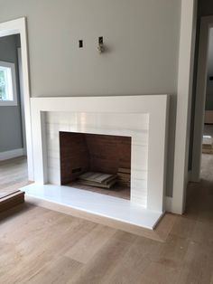 an empty living room with a fireplace in it