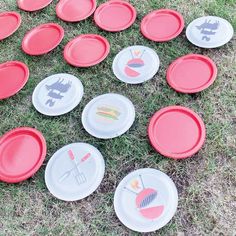 red and white frisbees are laid out on the grass