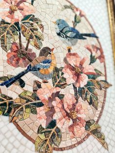 a mosaic table with flowers and birds on it