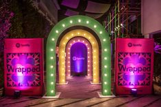 the entrance to disney's world of hollywood is lit up with colorful lights and decorations