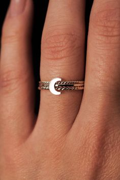 Dive into the celestial charm of our Moon Ring! The lunar-inspired design features a dainty moon on a simple, textured band - providing an adorable accent to any stack. The band measures approximately 1mm in width and features a lightly hammered finish. The moon detail measures approximately 6mm in width. This listing is for ONE SINGLE Moon Ring in STERLING SILVER metal. This ring is a great alternative to a stacking ring and is a perfect ring to mix and match with your favorite stacking rings. Every piece is organic and unique — no two Hannah Naomi pieces are exactly alike.Hand-crafted to order in our Portland, OR studio. Adjustable Moon Charm Promise Ring, Dainty Moon-shaped Midi Promise Rings, Adjustable Moon-shaped Stackable Rings For Promise, Dainty Adjustable Moon-shaped Midi Rings, Dainty Adjustable Moon Shape Midi Rings, Adjustable Moon-shaped Midi Promise Rings, Dainty Adjustable Ring With Moon Charm, Minimalist Open Ring With Moon Charm, Minimalist Moon Charm Open Ring