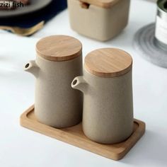 two coffee mugs sitting on top of a wooden tray