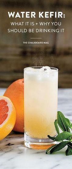 an orange and grapefruit next to a glass with water kefir what it is, why you should be drinking it