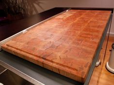 a wooden cutting board sitting on top of a counter