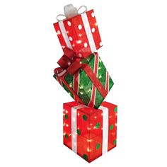 three presents stacked on top of each other with bows and lights around them, all wrapped in red and green paper