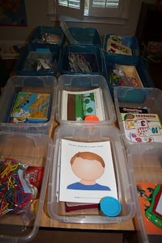 several plastic containers filled with children's books and toys