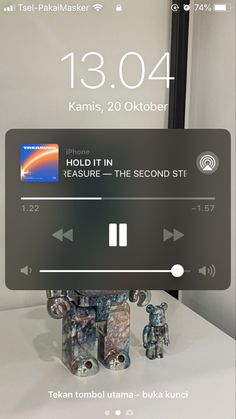 an image of a cell phone screen with music player on it and the time displayed