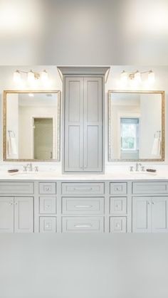 a large bathroom with double sinks and two mirrors on the wall next to each other