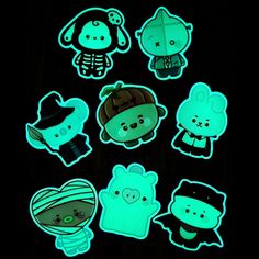 glow in the dark stickers on a black surface with various animals and people wearing hats